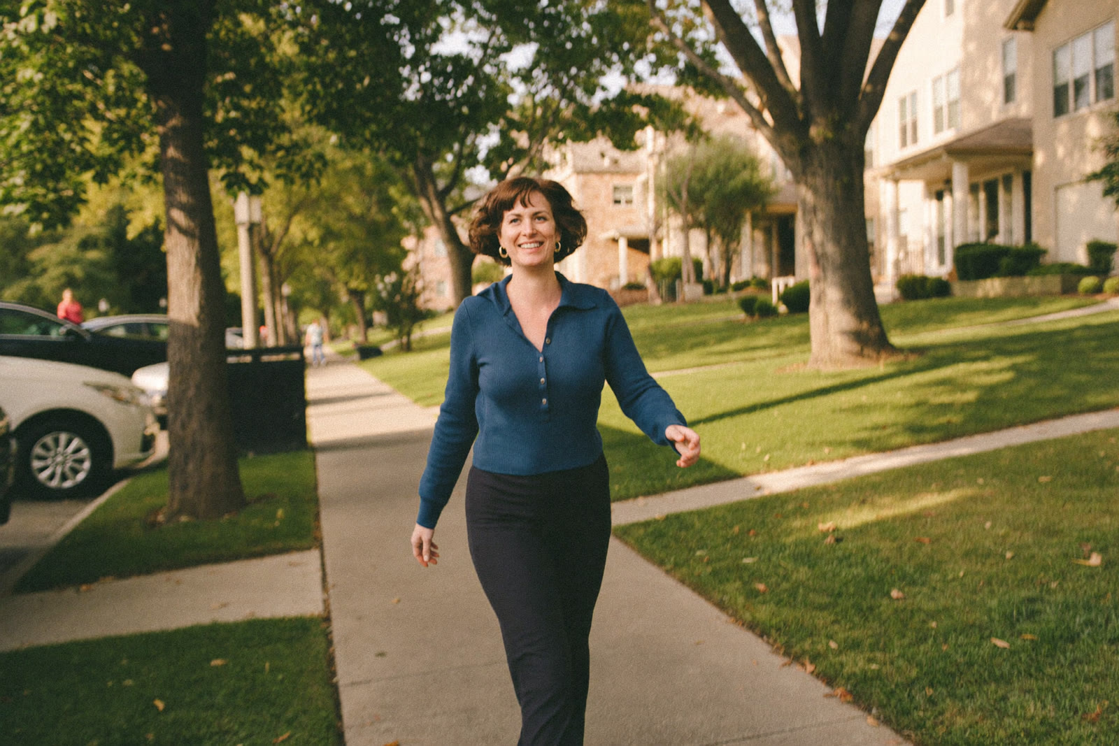 Woman walking pain-free through a Lombard, IL neighborhood after chronic pain treatment