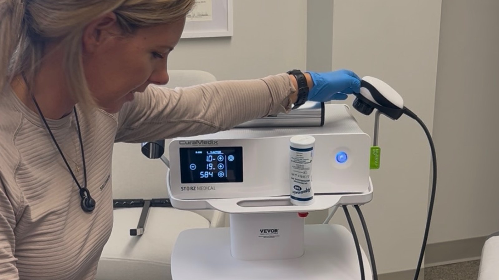 Dr. Amanda Myers preparing a Storz Medical radial shockwave device - radial vs focused shockwave therapy at True Health in Lombard IL