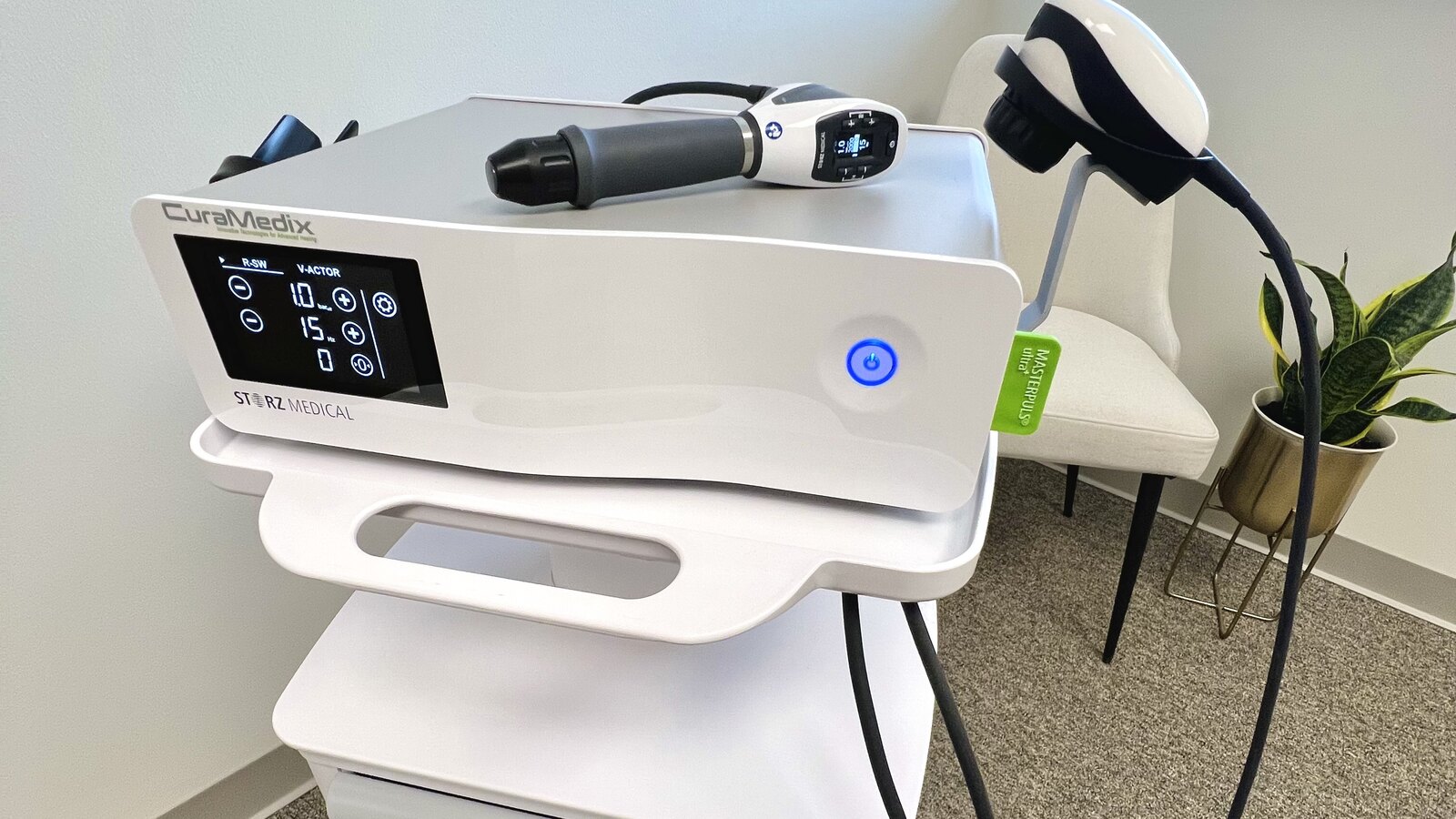 CuraMedix STORZ Medical shockwave therapy machine with handpieces in a treatment room at True Health Chiropractic in Lombard, IL