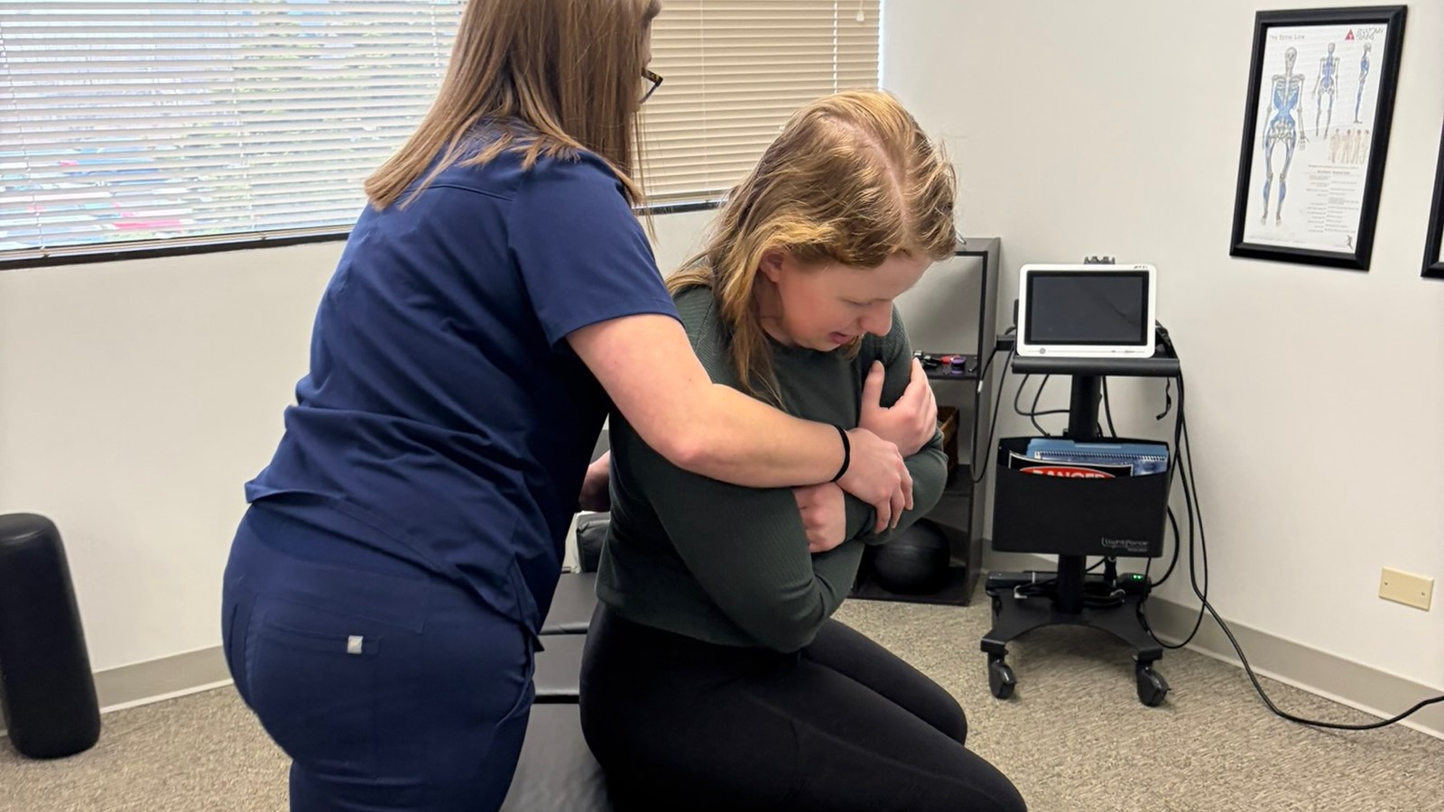 Dr. Amanda Myers performing a seated adjustment on a patient at True Health in Lombard, IL - can a herniated disc heal on its own