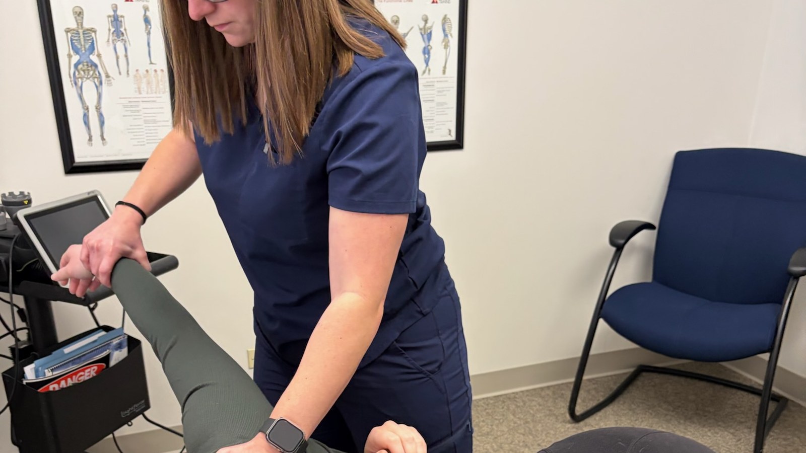 Chiropractor for anxiety-related tension: Dr. Amanda Myers checking shoulder and mid-back motion at True Health in Lombard, IL