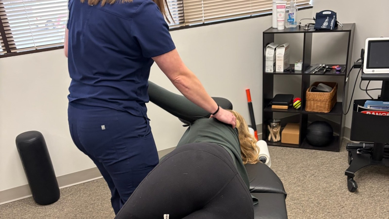 A chiropractor performing a side-posture hip and low back adjustment at True Health in Lombard, IL - sciatica vs piriformis syndrome